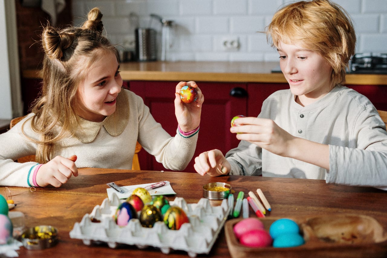 Children cracking decorated eggs