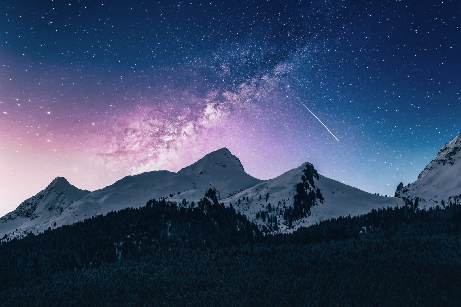 A starry night sky over a mountain landscape